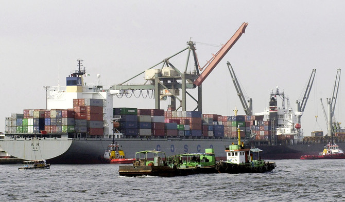 In this file photo, Pakistani vessels pass by container ships being loaded with cargo at the port of Karachi, Sept. 8, 2003. (AFP)