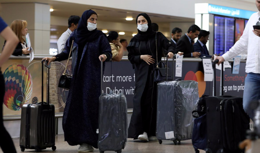 Travelers wear masks as they arrive at Dubai International Airport on January 29, 2020. (Reuters)