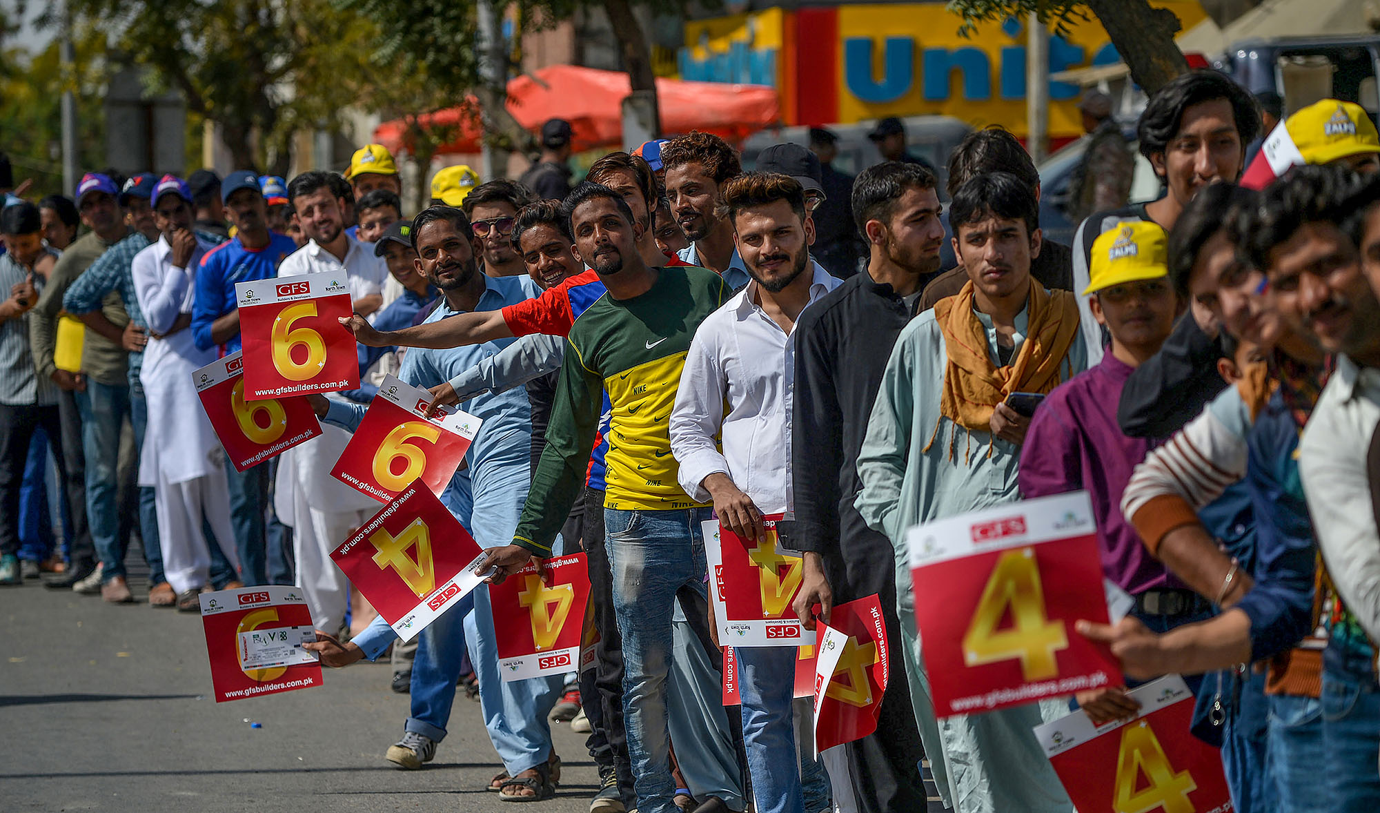 Spectators stand in a queue to enter the National Cricket Stadium in Karachi on February 21, 2020, ahead of the start of the Pakistan Super League (PSL) T20 cricket match between Peshawar Zalmi and Karachi Kings. (AFP)