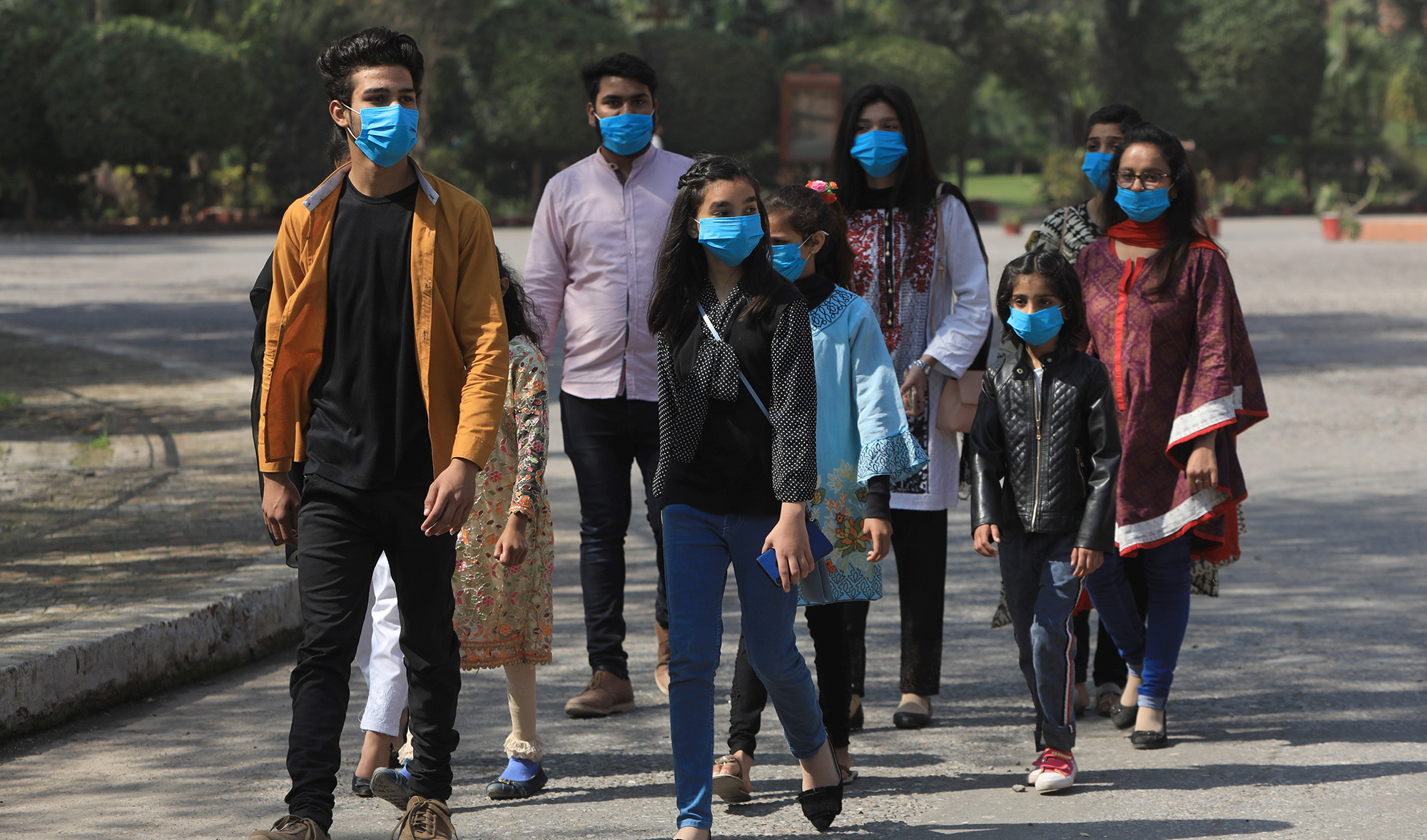 Volunteers wear masks as a preventive measure against the coronavirus, as they walk during an awareness compaign by a NGO at the premises of the St John Cathedral in Peshawar, Pakistan March 15, 2020. REUTERS/Fayaz Aziz