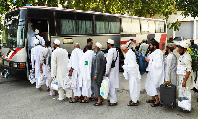 Pakistani Hajj pilgrims queued to embark onto a bus at The Hajj Complex in Islamabad on August 23, 2016, before leaving for the annual Hajj pilgrimage to the Islamic holy cities of Mecca and Medina in Saudi Arabia. (AFP)