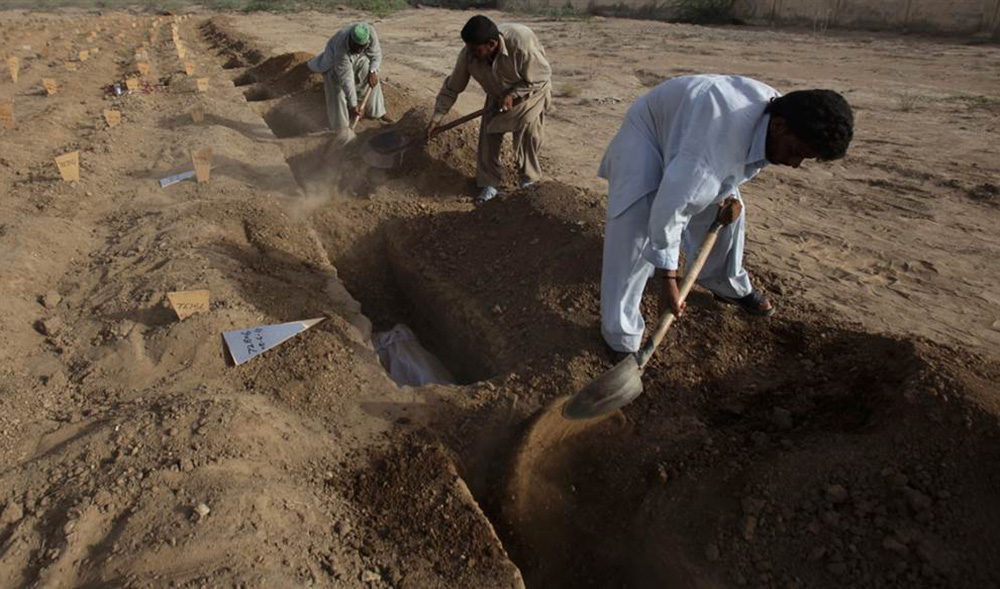 In this file photo, employees of the Edhi center lay unidentified bodies to rest at the Edhi graveyard in Karachi on June 8, 2011. (REUTERS)