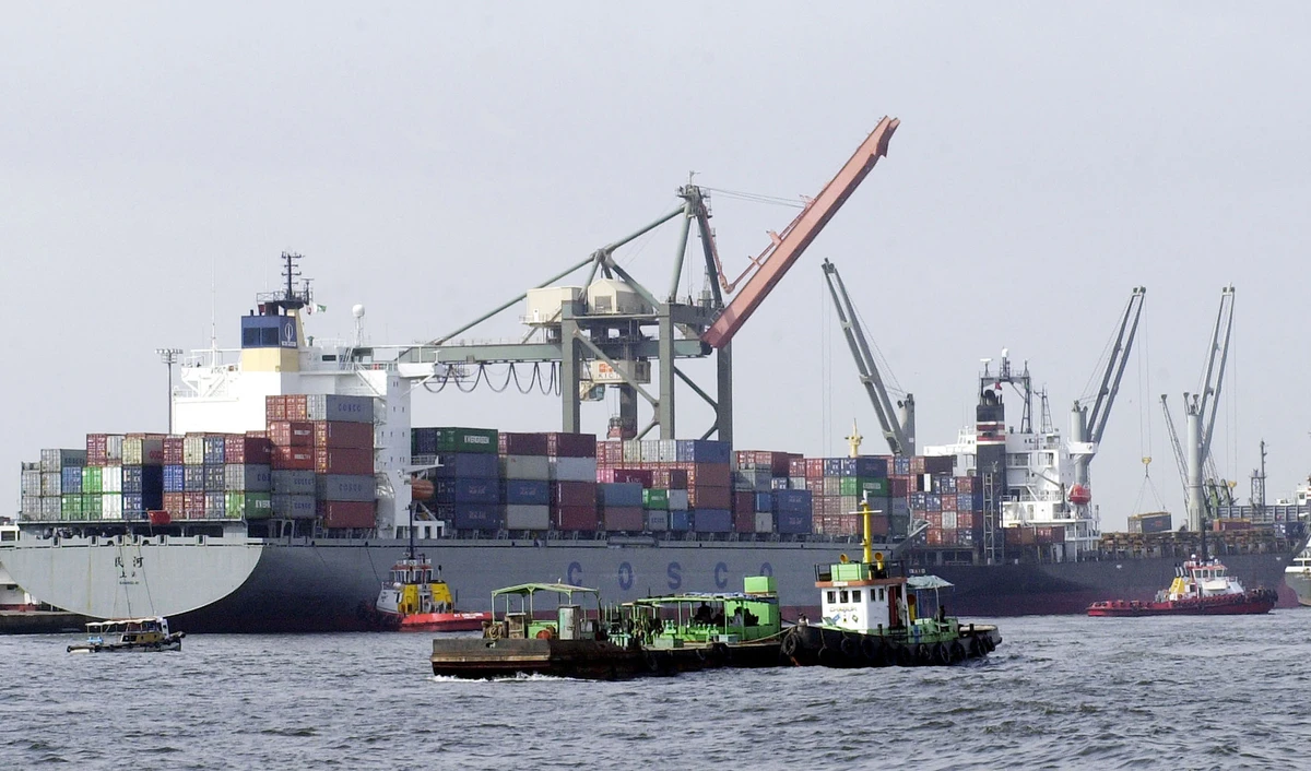 In this file photo, Pakistani vessels pass by container ships being loaded with cargo at the port of Karachi on Sept 8, 2003. (AFP)