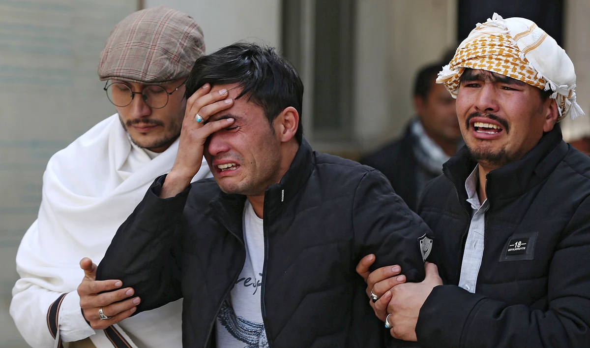 Afghan men cry at a hospital after they heard that their relative was killed during an attack in Kabul, Afghanistan March 6, 2020. (REUTERS)