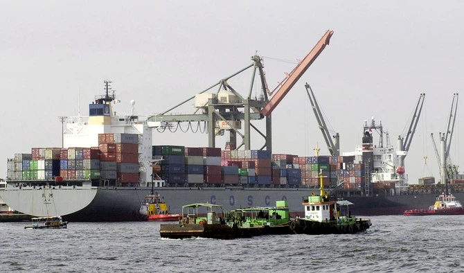 In this file photo, Pakistani vessels pass by container ships being loaded with cargo at the port of Karachi, Sept. 8, 2003. (AFP)