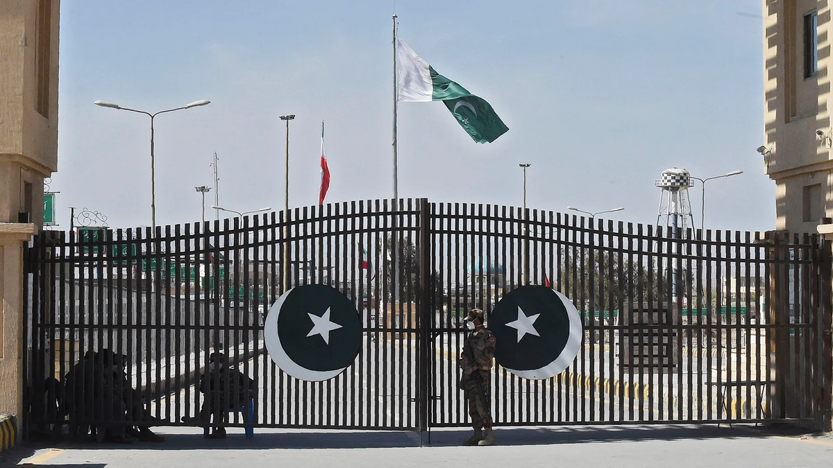 In this file photo, Pakistani soldiers wearing facemasks stand guard at the closed Pakistan-Iran border in Taftan on February 25, 2020 as fears over the spread of the COVID-19 coronavirus escalate following an outbreak in neighboring Iran. (AFP)
