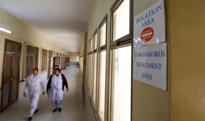 Paramedic staff walk at an isolation section, set up for the precautionary measures for the coronavirus patients treatment, at the Jinnah Postgraduate Medical Center in Karachi. (Reuters)