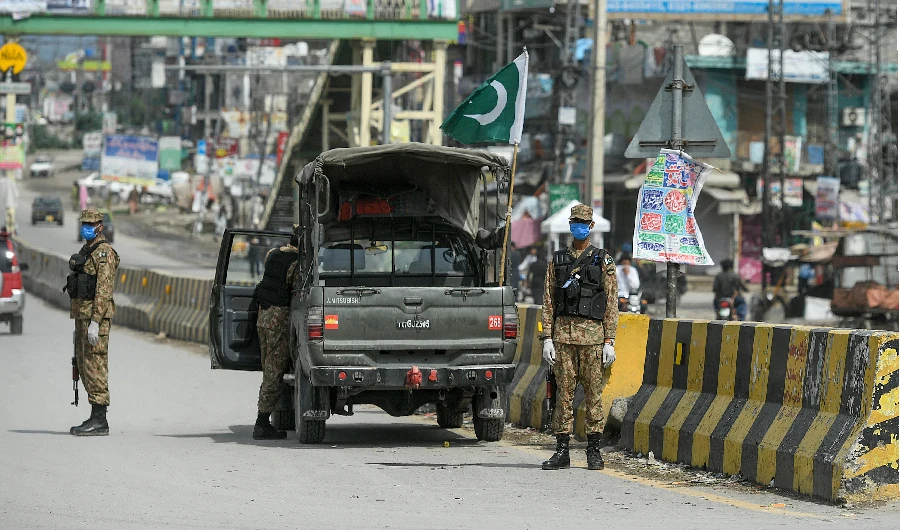 Security personnel wearing facemasks patrol in Bhara Kahu area during a government-imposed lockdown as a preventive measure against the COVID-19 coronavirus, in Islamabad on March 25, 2020. (AFP)