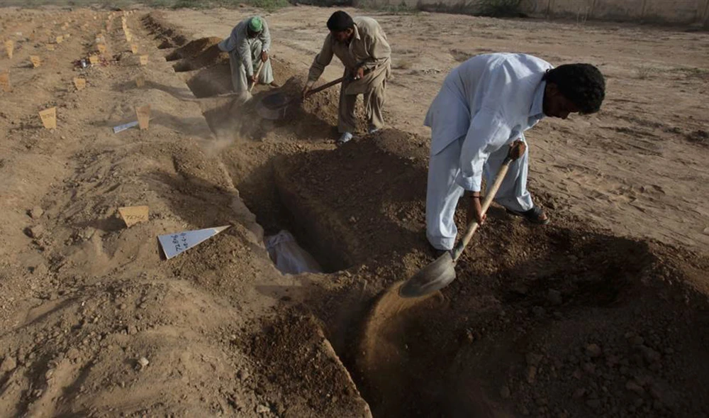 In this file photo, employees of the Edhi center lay unidentified bodies to rest at the Edhi graveyard in Karachi on June 8, 2011. (REUTERS)
