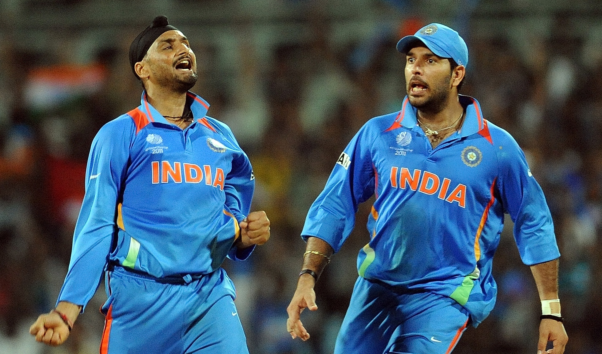 In this file photo, Indian bowler Harbhajan Singh, left, celebrates the wicket of unseen West Indies batsman Kieron Pollard with Yuvraj Singh during the Cricket World Cup match in Chennai on March 20, 2011. (AFP)