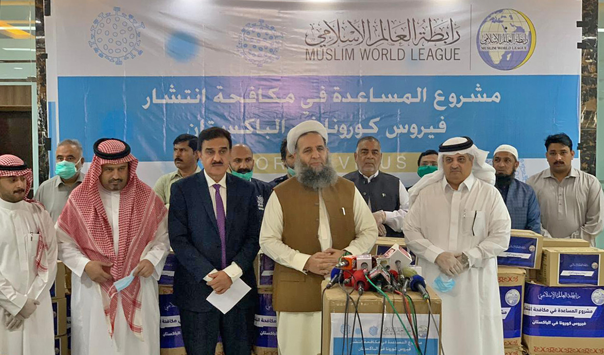 Pakistan's Religious Affairs Minister Noor-ul-Haq Qadri and Saudi Ambassador Nawaf bin Saeed Al-Maliki can be seen together at a ceremony in Islamabad on April 1, 2020, after the Muslim World League, a Makkah-based organization, gave necessary items to the Pakistani government to fight the spread of coronavirus. (Photo courtesy: Ministry of Religious Affairs)