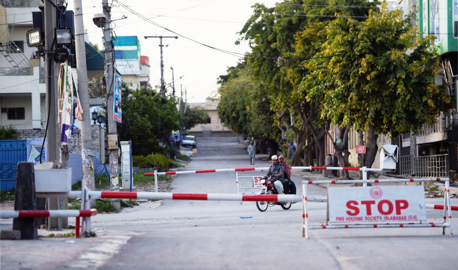 A motorist ride along a deserted road during a government-imposed nationwide lockdown as a preventive measure against the COVID-19 coronavirus in Islamabad on March 29, 2020.(AFP)