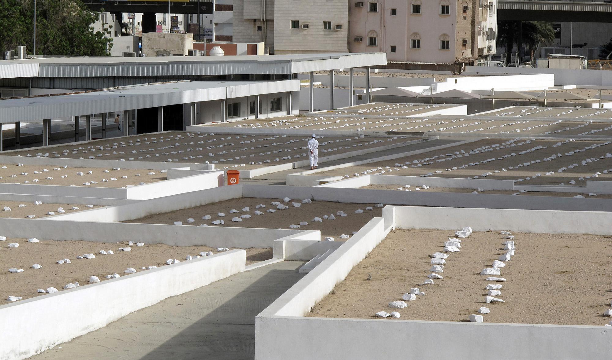 In this file photo, a Saudi man walks past graves at a cemetery in Makkah on May 30, 2010. (AFP)