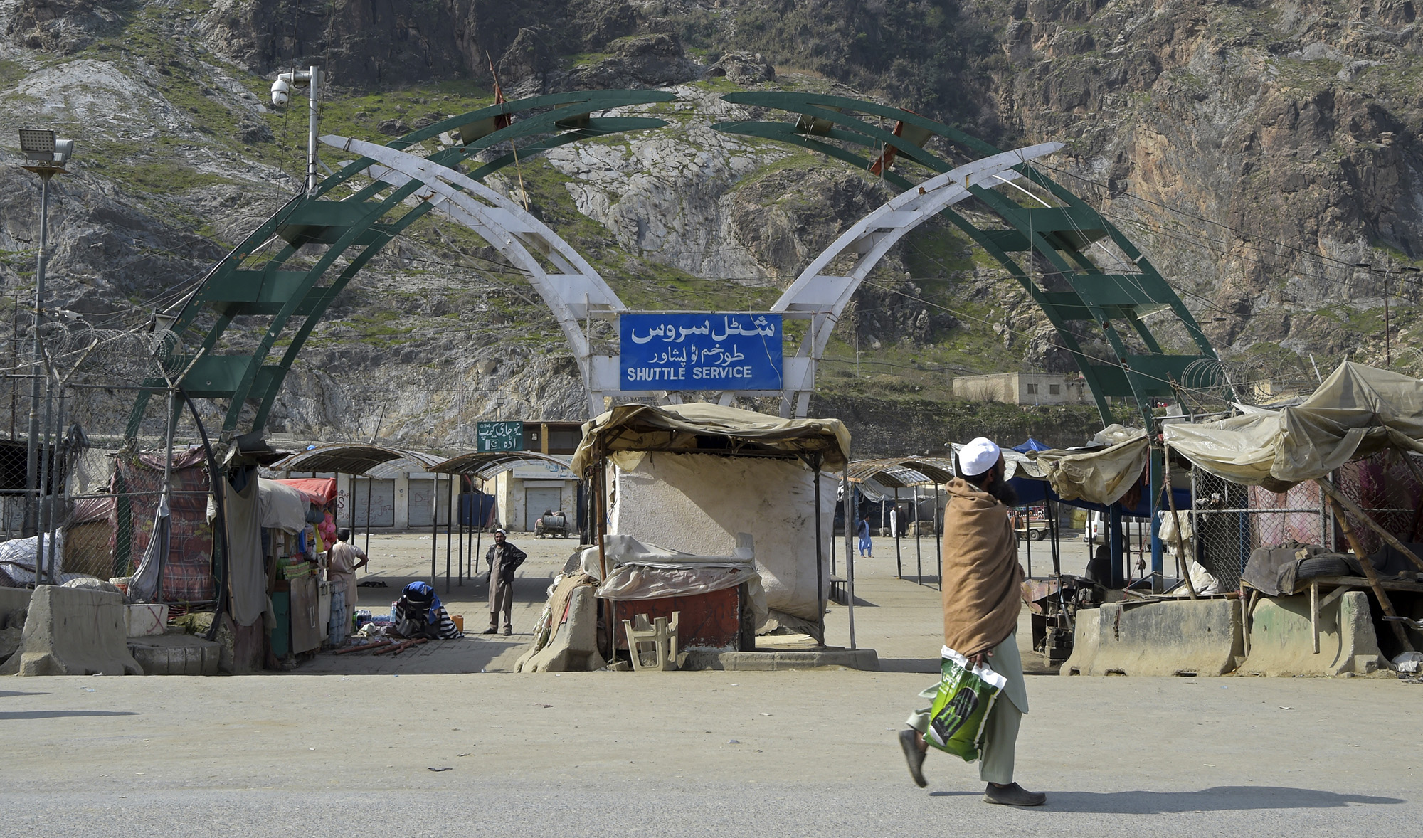 A man walks past an empty bus terminal near the closed Pakistan-Afghanistan border amid concerns over the spread of the COVID-19 novel coronavirus, in Torkham some 54 kms from Peshawar on March 16, 2020. (AFP)