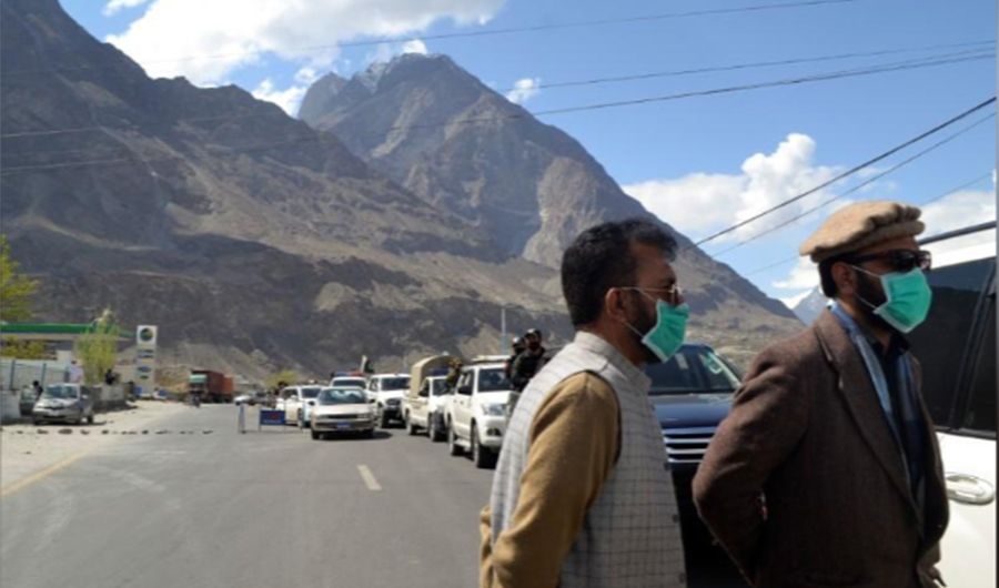 Men wear protective face masks as a preventive measure against coronavirus disease (COVID-19) outbreak as they stand by a queue of vehicles at a check post while entering Gilgit, Pakistan March 22, 2020. (REUTERS)