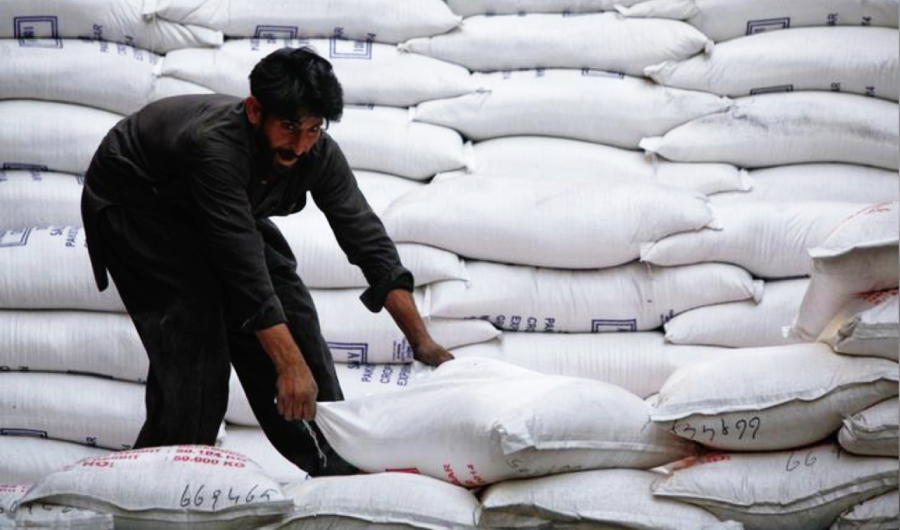 A laborer unloads sacks of sugar from a supply truck at the main wholesale market in Karachi February 19, 2012. (REUTERS/File photo)
