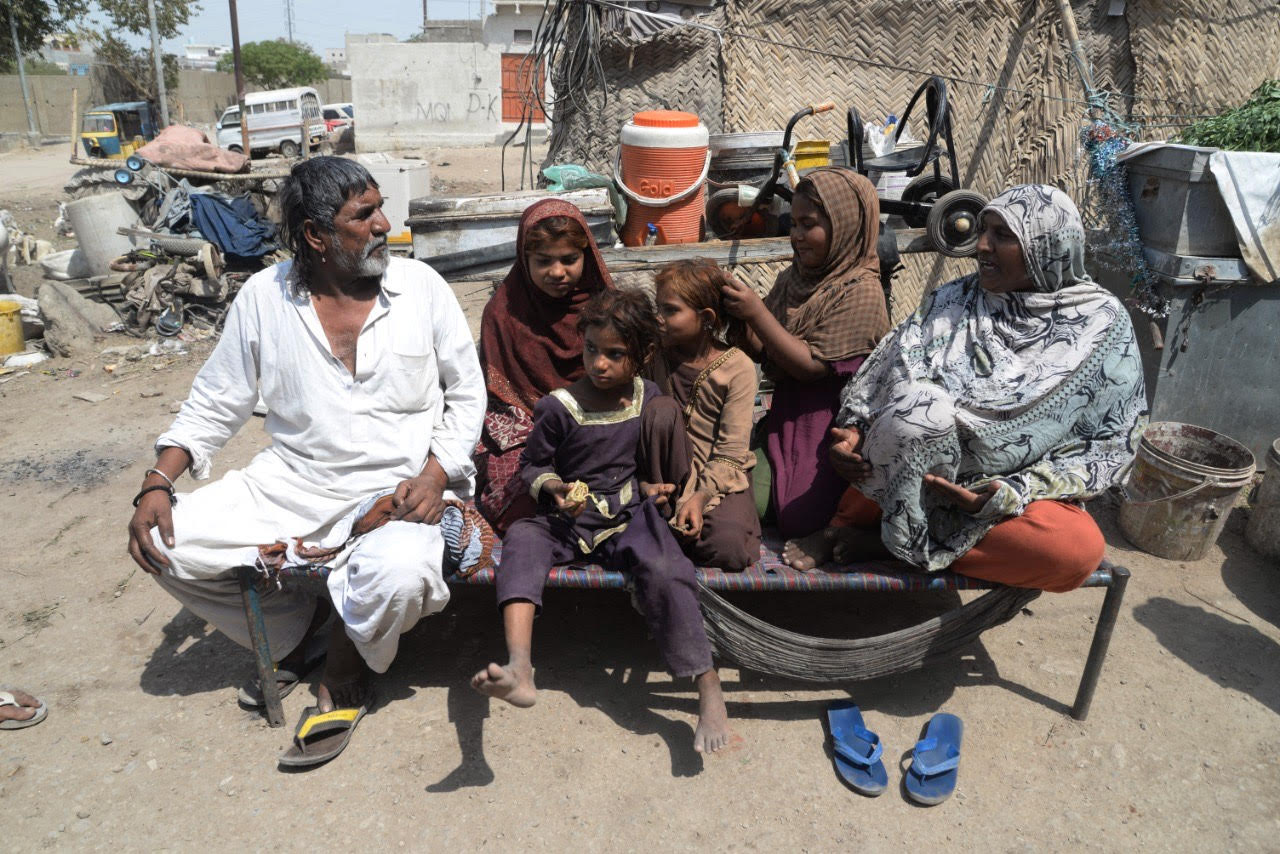 Nazir Hussain (left), a sole bread earner of five, including four daughters, sit with his family in a shanty in outskirt of the city on Monday, March 23, 2020. He collects used stuff on his cart and has not been out for last five days due to fear of coronavirus. He says a fourteen day curfew will further force him to stay at home without any food. “If the government has imposed curfew, it needs to provide us food for the day,” Hussain told Arab News (AN photo by S.A. Babar)