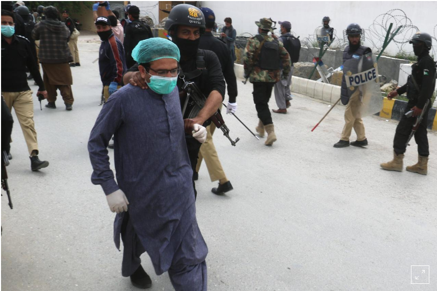 A police officer detains a doctor who along with others demonstrates against the lack of protective gears for medical staff who are treating coronavirus disease (COVID-19) patients in Quetta, Pakistan April 6, 2020. (REUTERS)