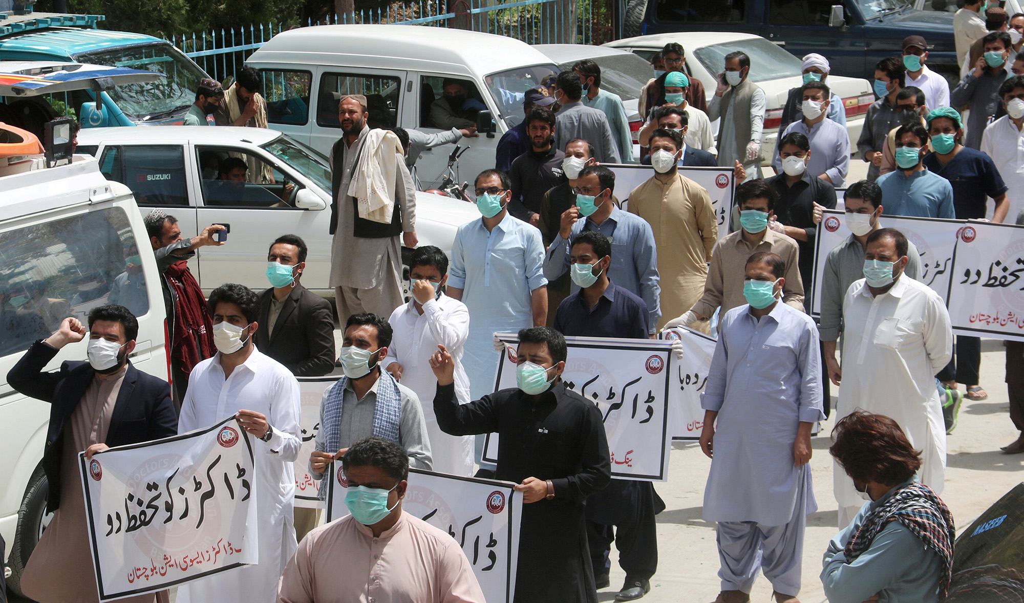 Doctors wearing face masks chant slogans during a protest against the lack of protective gears for medical staff who are treating coronavirus disease (COVID-19) patients in Quetta on April 6, 2020. (REUTERS)