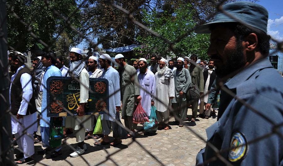 In this file photo, Afghan prisoners walk as they leave prison in the city of Jalalabad, Nangarhar province on May 20, 2014. (AFP)