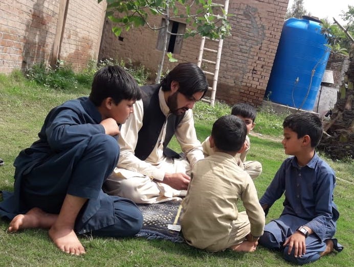 Adil Rehman with his three sons after returning from an isolation ward for coronavirus patients in Peshawar on April 6, 2020. (Photo Courtesy: Adil Rehman)