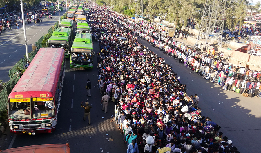 In this file photo taken on March 28, 2020 Migrant workers and their family members lineup outsdie the Anand Vihar bus terminal to leave for their villages during a government-imposed nationwide lockdown as a preventive measure against the COVID-19 coronavirus in New Delhi on March 28, 2020. (AFP)
