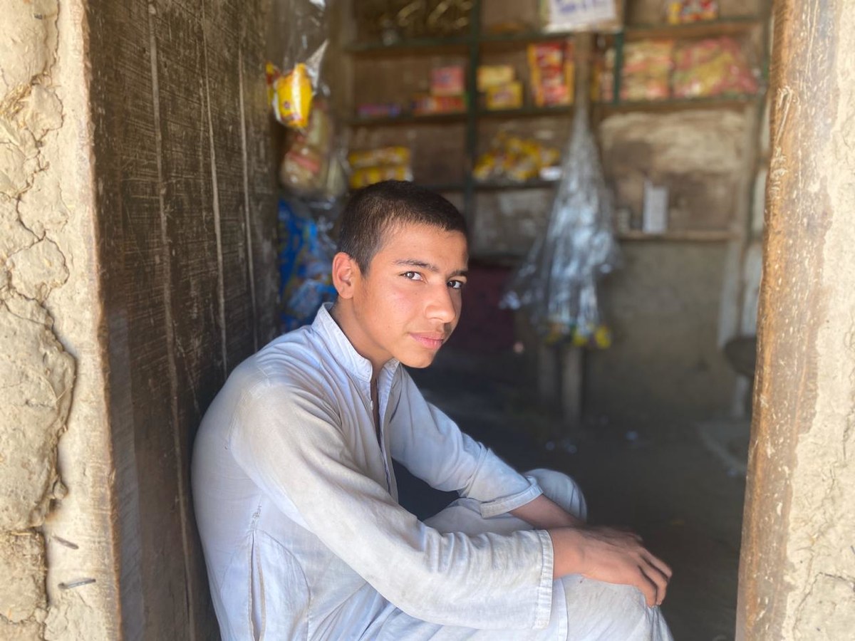 Tariq Jan is sitting at his tiny shop in the Jalala refugee camp on April 9, 2020. He says people have stopped coming because they have no money to buy food. (AN Photo)