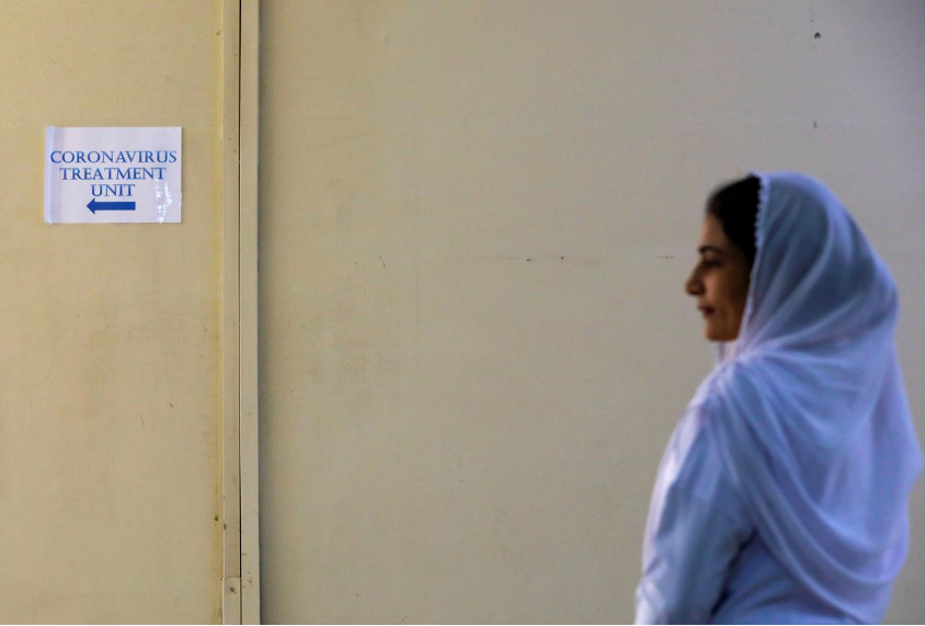 A paramedic staff stands outside an isolation section, set up for the precautionary measures for the coronavirus patients treatment, at the Jinnah Postgraduate Medical Center (JPMC) in Karachi, Pakistan February 3, 2020. (REUTERS)