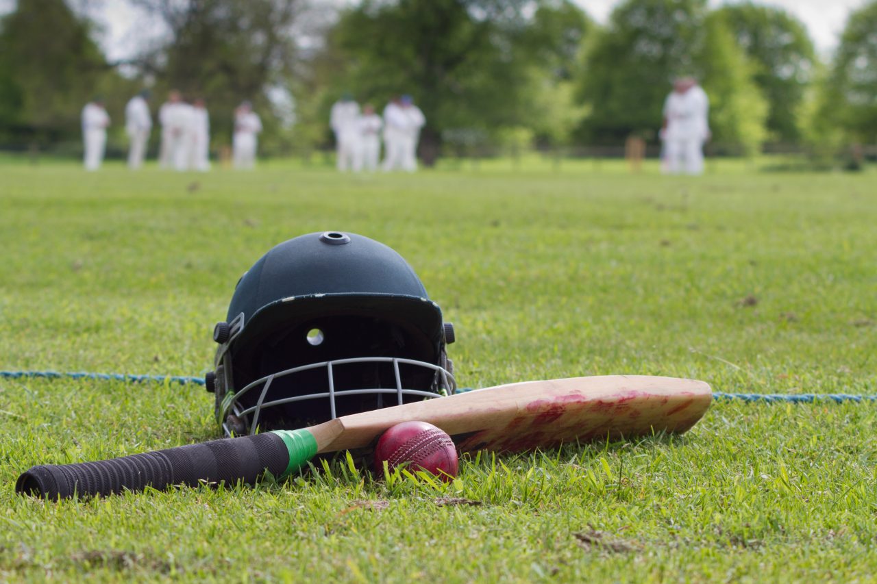 This undated file photo shows a cricket helmet, bat and ball on boundary line during a game in the English village. (Shutterstock)