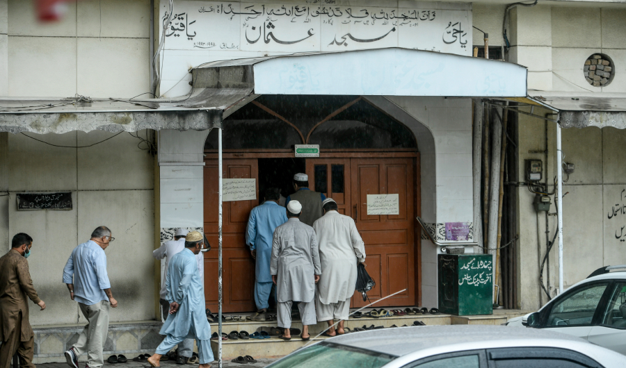 Muslims enter a mosque as they arrive to offer Friday prayers during a government-imposed nationwide lockdown as a preventive measure against the COVID-19 coronavirus, in Islamabad on April 17, 2020. (AFP)