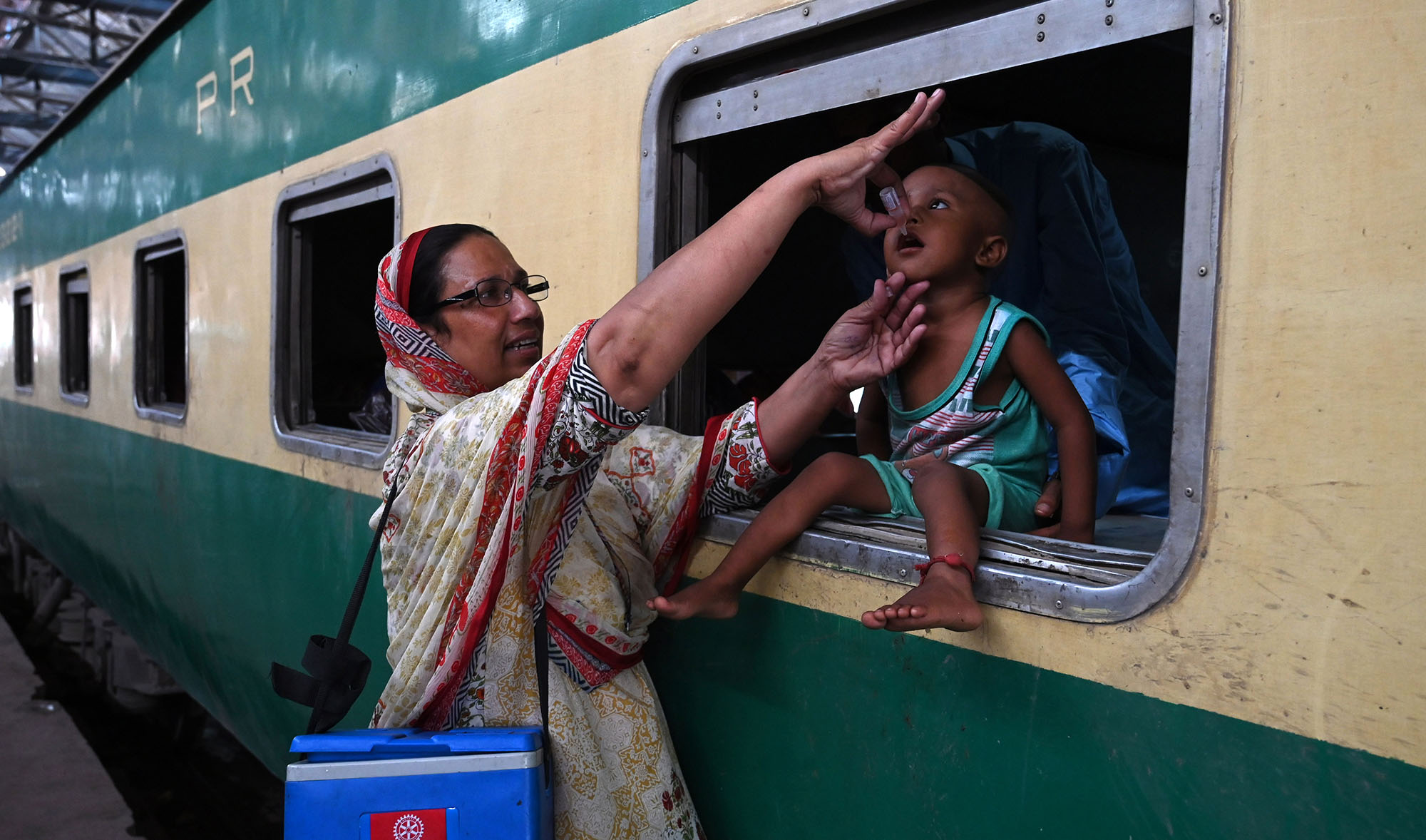 In this file photo, a Pakistani health worker administers polio drops to a child at a railway station during a polio vaccination campaign in Lahore on Aug. 27, 2019. (AFP)