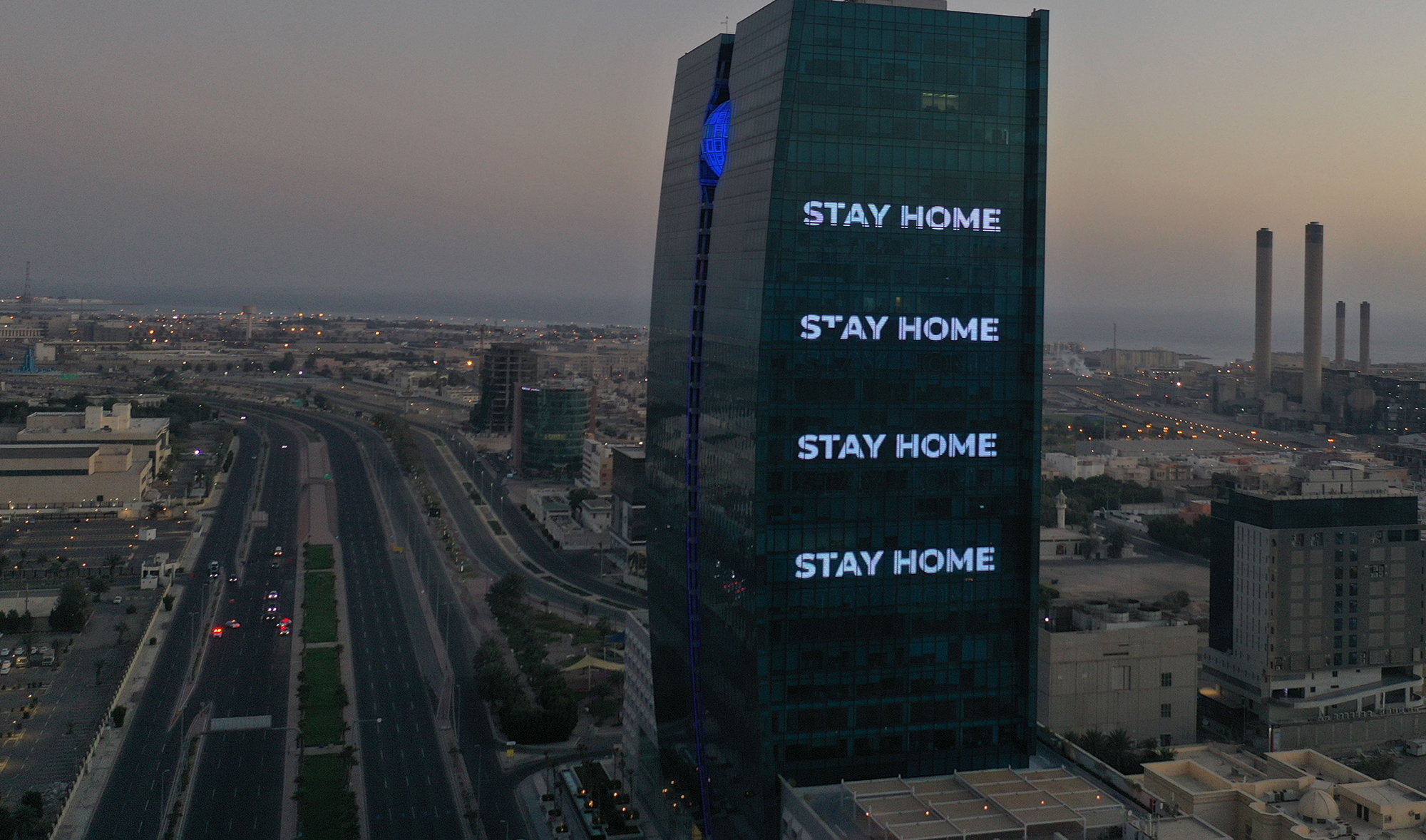 An aerial view shows deserted streets in the Saudi coastal city of Jeddah on April 21, 2020, as the message "stay home" is displayed on a tower during the novel coronavirus pandemic crisis. (AFP)