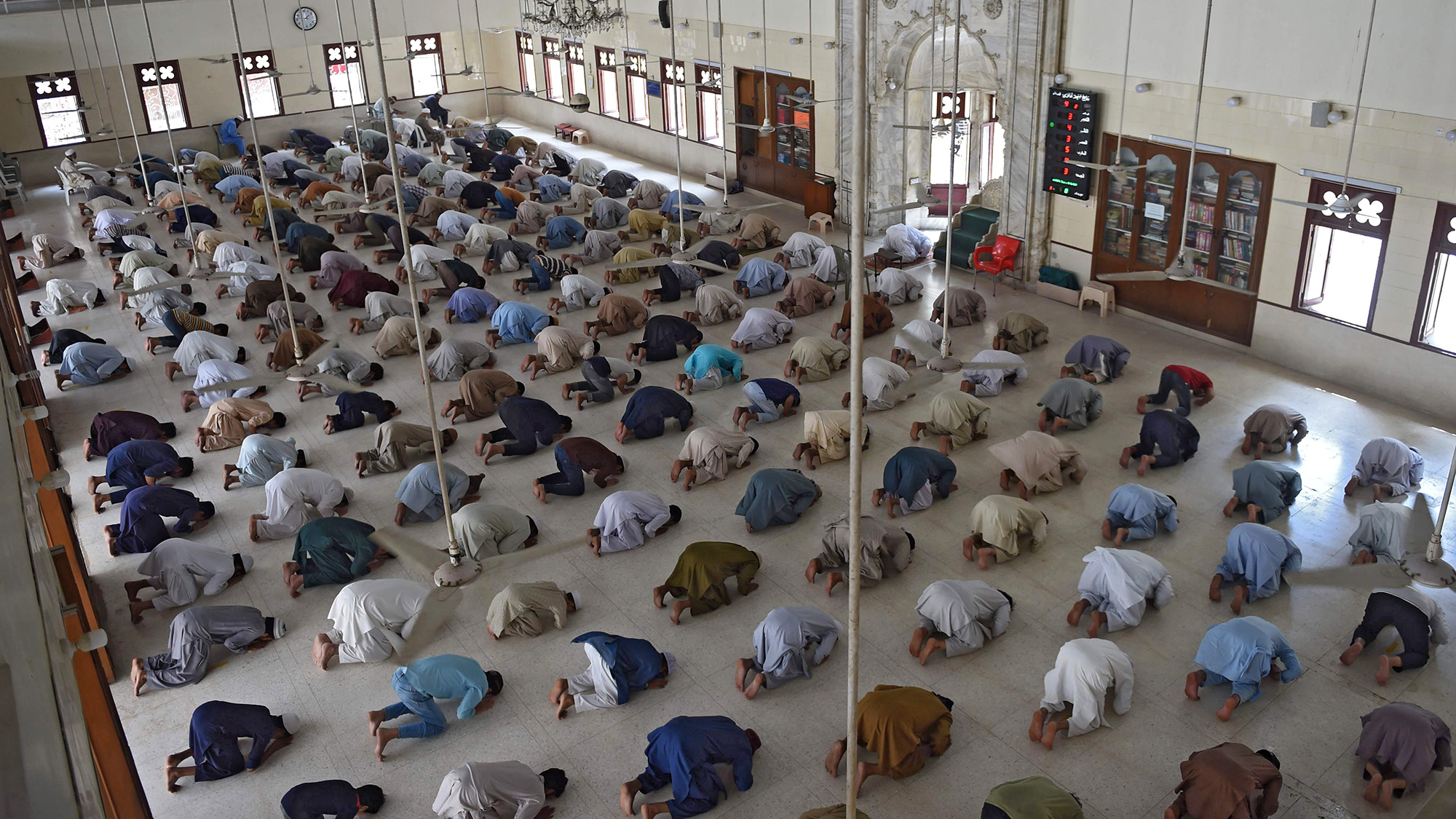 In this picture taken on April 19, 2020, Muslim worshippers maintain social distancing during noon prayers at a mosque in Karachi during a government-imposed nationwide lockdown as a preventive measure against the COVID-19 coronavirus. (AFP)