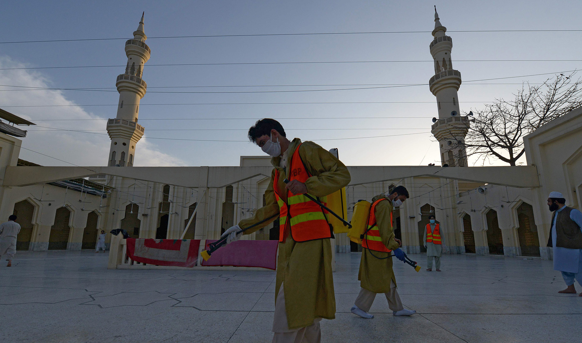 Muslim devotees spray disinfectant in a Mosque ahead of the Muslim holy month of Ramadan during a government-imposed nationwide lockdown as a preventive measure against the COVID-19 coronavirus, in Peshawar on April 23, 2020. (AFP)