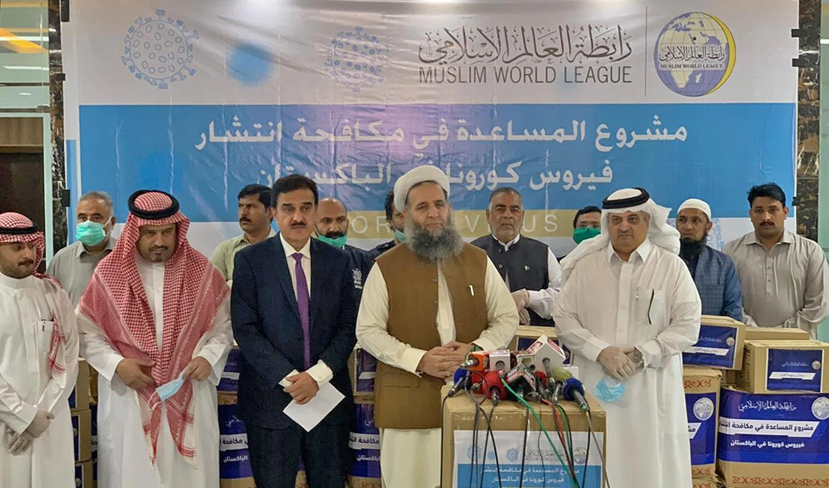 Pakistan's Religious Affairs Minister Noor-ul-Haq Qadri and Saudi Ambassador Nawaf bin Saeed Al-Maliki can be seen together at a ceremony in Islamabad on April 1, 2020, after the Muslim World League, a Makkah-based organization, gave necessary items to the Pakistani government to fight the spread of coronavirus. (Photo courtesy: Ministry of Religious Affairs)