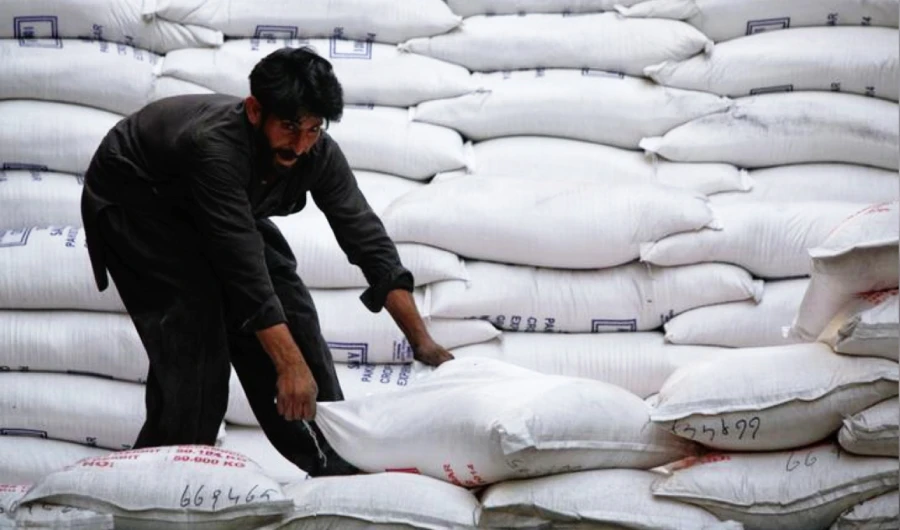 A laborer unloads sacks of sugar from a supply truck at the main wholesale market in Karachi February 19, 2012. (REUTERS/File photo)