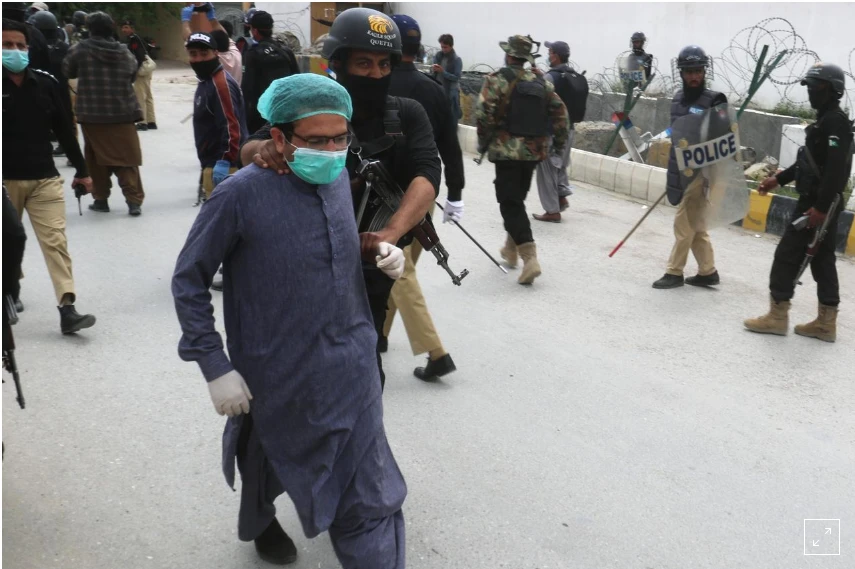 A police officer detains a doctor who along with others demonstrates against the lack of protective gears for medical staff who are treating coronavirus disease (COVID-19) patients in Quetta, Pakistan April 6, 2020. (REUTERS)