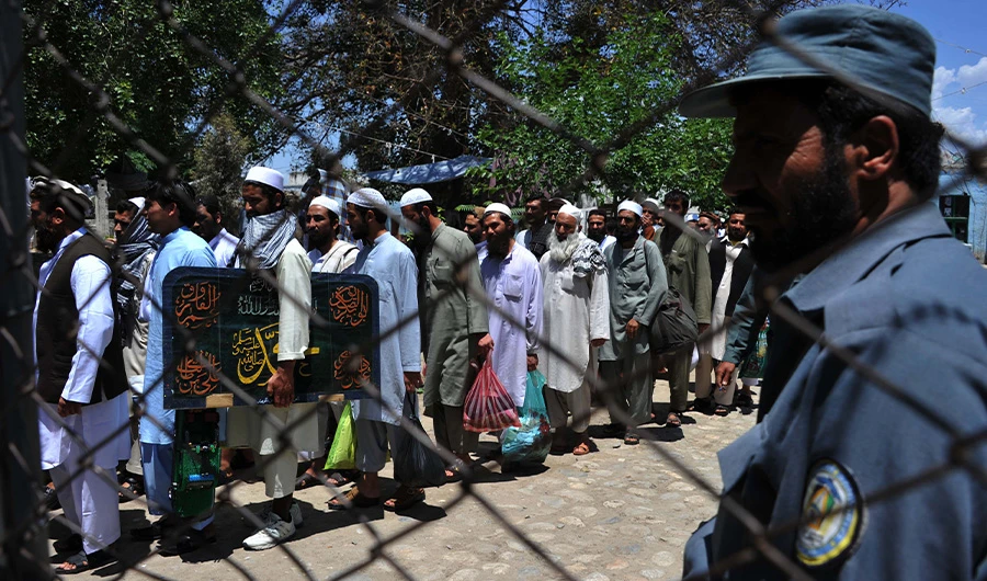 In this file photo, Afghan prisoners walk as they leave prison in the city of Jalalabad, Nangarhar province on May 20, 2014. (AFP)