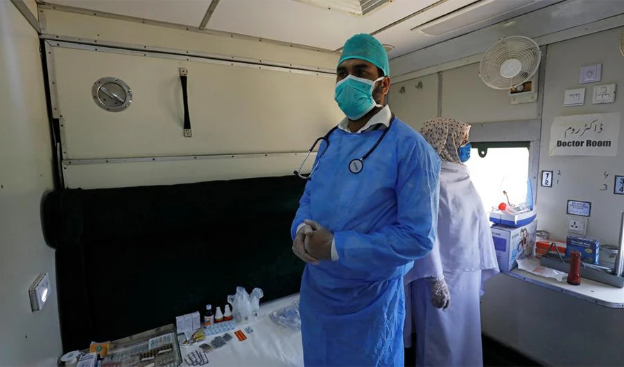 A doctor and nurse wear protective masks as they stand in a passenger train's car after the government turned it into a hospital and quarantine centre following the coronavirus outbreak in Karachi, Pakistan, March 31, 2020. (Reuters)