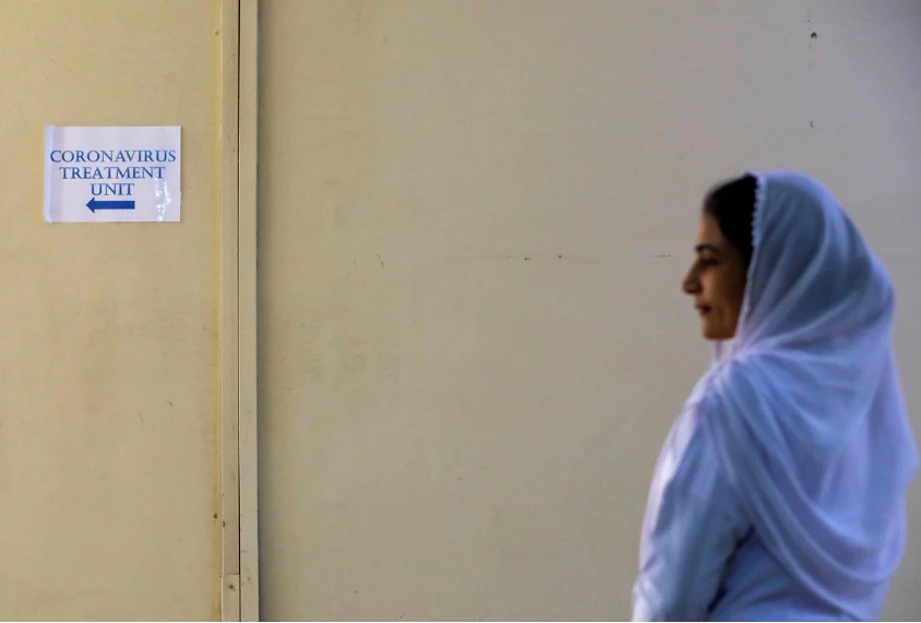 A paramedic staff stands outside an isolation section, set up for the precautionary measures for the coronavirus patients treatment, at the Jinnah Postgraduate Medical Center (JPMC) in Karachi, Pakistan February 3, 2020. (REUTERS)