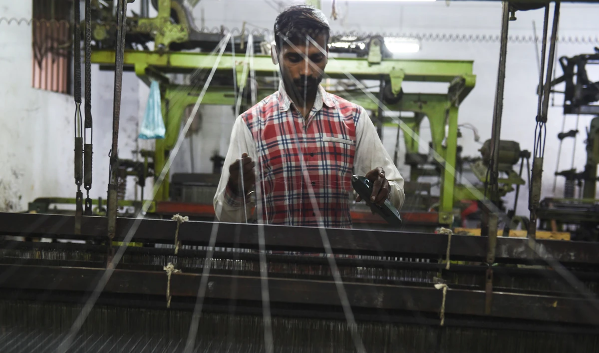 In this file photo, a laborer works on a loom at a factory in Pakistan's port city of Karachi on Jan. 17, 2020. (AFP)