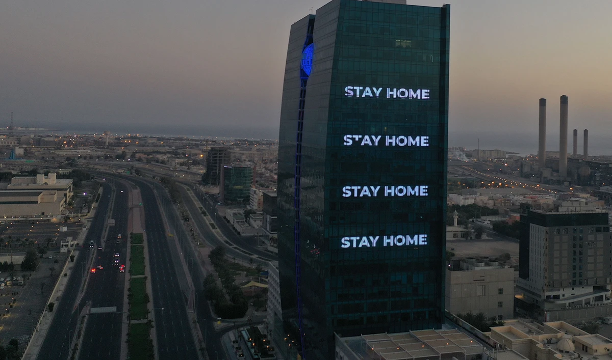 An aerial view shows deserted streets in the Saudi coastal city of Jeddah on April 21, 2020, as the message "stay home" is displayed on a tower during the novel coronavirus pandemic crisis. (AFP)
