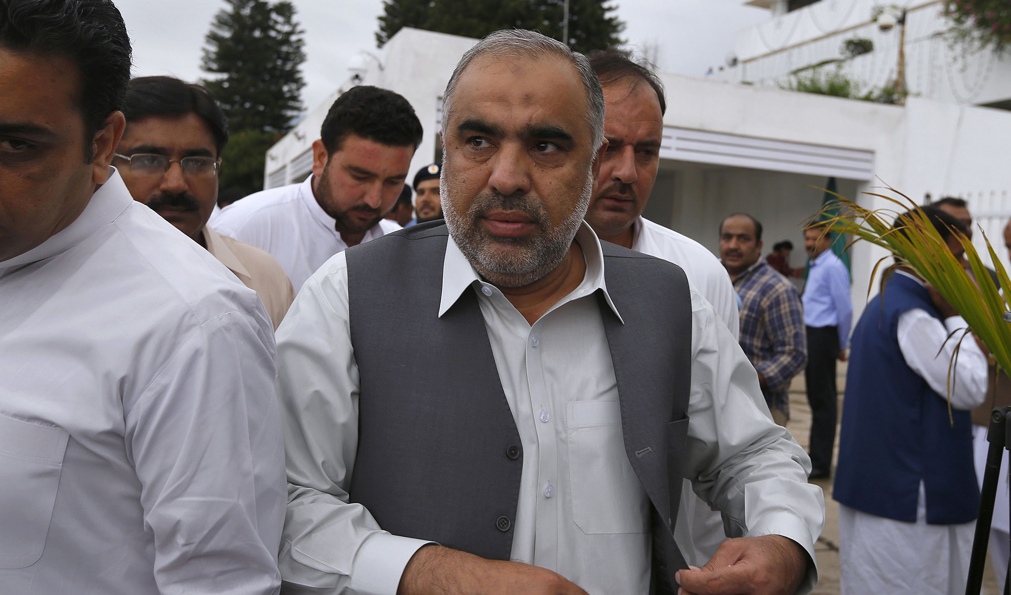 In this file photo, Speaker of the National Assembly Asad Qaiser, center, arrives to attend the first session of the lower house of parliament, in Islamabad on Aug. 13, 2018. (AP)