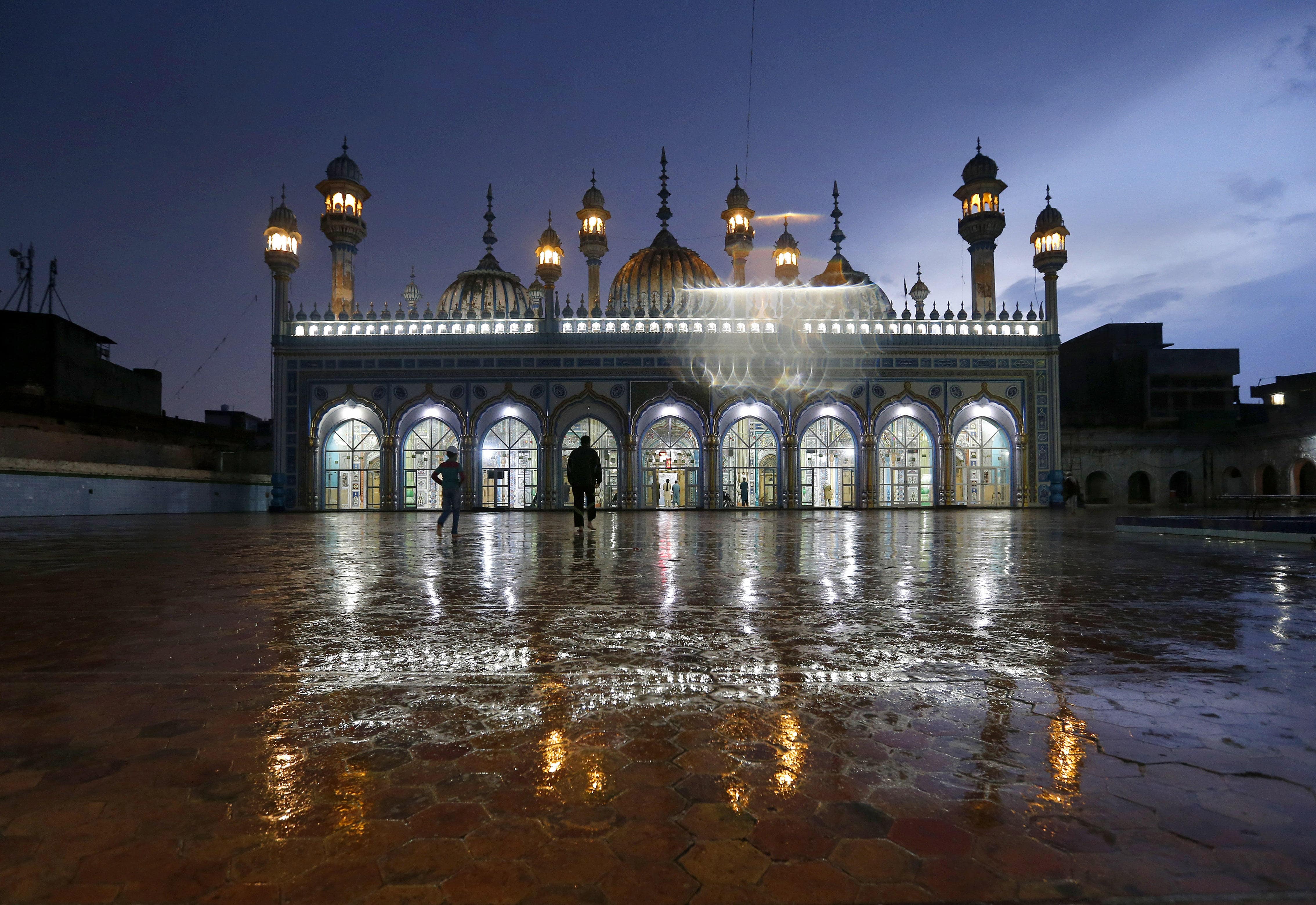 Muslim worshipers arrive for evening prayers after breaking their fast on the first day of Ramadan, in Rawalpindi, Pakistan, April 25, 2020. Pakistan on May 4 said it is going to further ease coronavirus lockdowns to resume economic activity. (AP Photo)