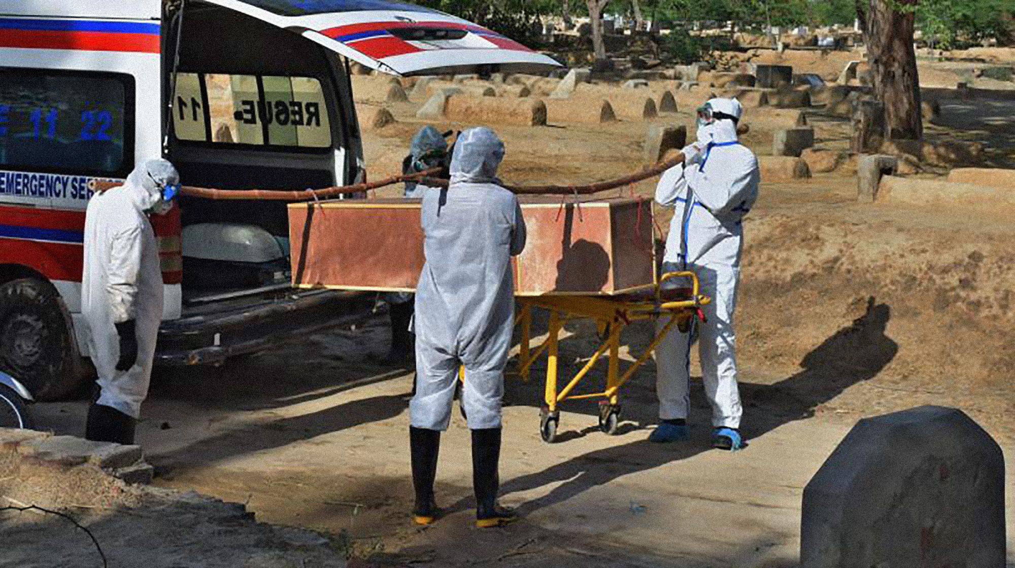 In this file photo, municipality workers wearing protective suits prepare to bury a coronavirus victim at a cemetery on the outskirts of Bahawalpur, in central Pakistan, Sunday, April 5, 2020. (AP)
