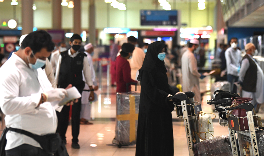 Pakistani nationals check in at the Dubai International Airport before leaving the Gulf Emirate on a flight back to their country, on May 7, 2020, amid the novel coronavirus pandemic crisis. (AFP)