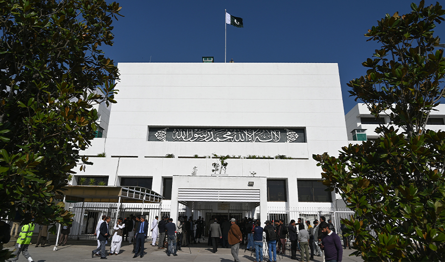 In this file photo, Pakistani media personnel gather outside the Parliament building during a joint session in Islamabad on February 28, 2019. (AFP)