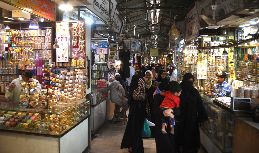 People shop in a market after the government eased the nationwide lockdown imposed as a preventive measure against the COVID-19 coronavirus, in Karachi on May 11, 2020. (AFP)