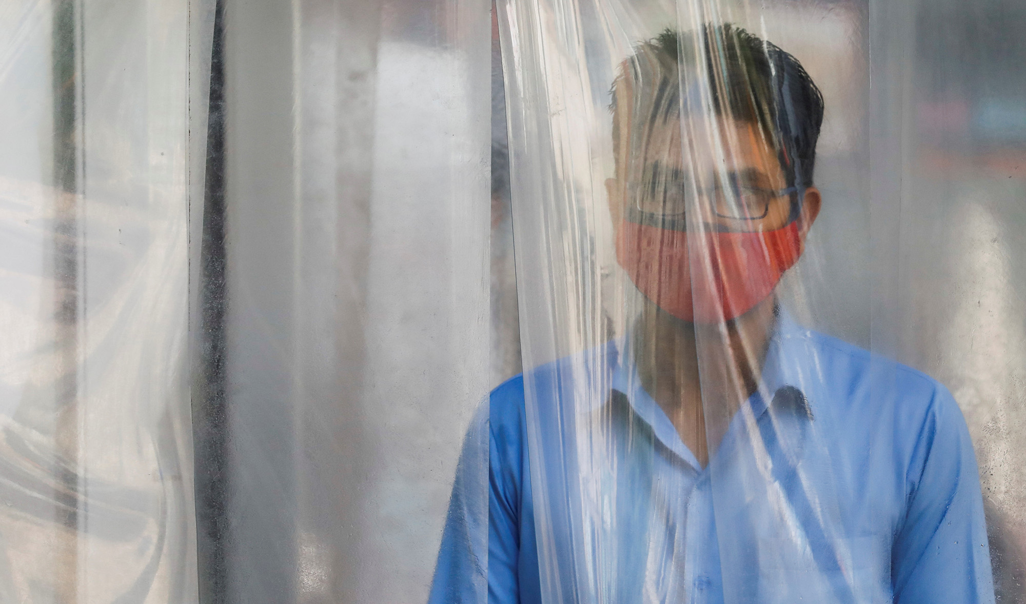 A man wears a protective mask as he gets sanitized before entering a shopping mall, after Pakistan started easing the lockdown restrictions, amid the coronavirus disease (COVID-19) outbreak, in Karachi on May 18, 2020. (REUTERS)