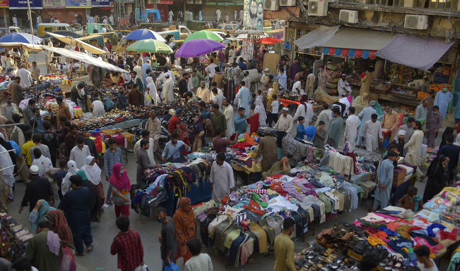 Peoples walk along Raja Bazar ahead of the Muslim Eid al-Fitr festival after the government eased a nationwide lockdown imposed as a preventive measure against the COVID-19 coronavirus in, in Rawalpindi on May 19, 2020. (AFP)